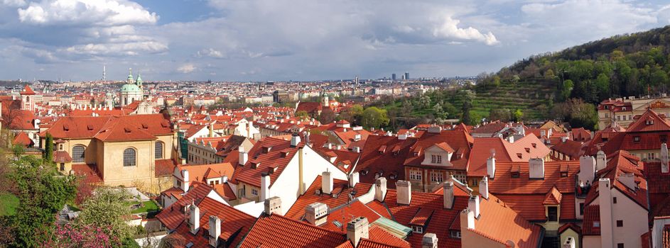 Panoramatic photo of Czech Capital Prague from the Castle at roofs of Old Town with a park