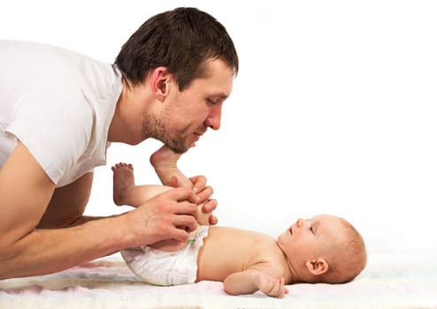 Young Caucasian father playing with baby son over white background
