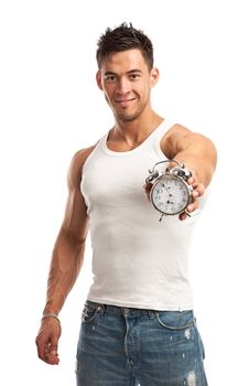 Cropped view of a muscular young man holding clock over white background. It is time for workout concept.
