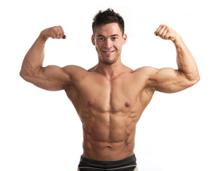 Waist-up portrait of muscular man flexing his biceps against white background