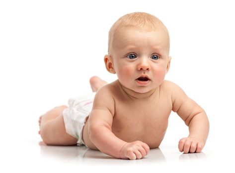 Cute baby boy lying on stomach over white background