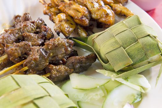 Chicken Beef and Mutton Satay with Ketupat and Cucumbers Closeup