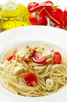 pasta garlic olive oil and red chili pepper closeup on a white dish