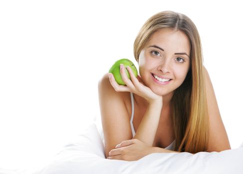 Smiling Young Woman Holding Apple in Bed