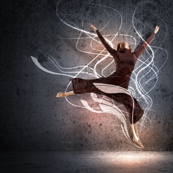 Girl dancing in a color dress with a gray background. Collage