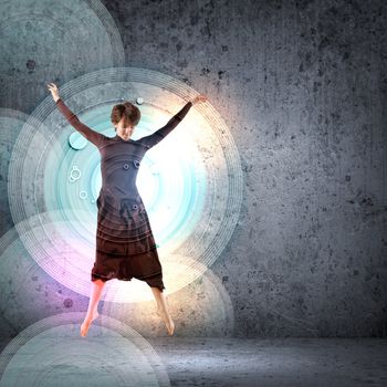 Girl dancing in a color dress with a gray background. Collage