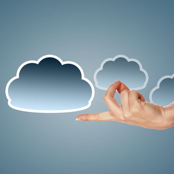 Hand with cloud computing symbol against colour background