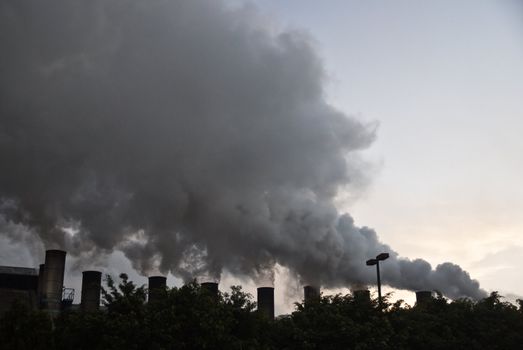 TEPIC, NAYARIT/MEXICO – FEBRUARY 22: Smoke from sugar mills pollutes the air in industrial zone shown on February 22 2010 in Tepic, Mexico. Tepic is the state capital and was founded in 1542.