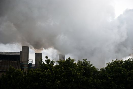 TEPIC, NAYARIT/MEXICO – FEBRUARY 22: Smoke from sugar mills pollutes the air in industrial zone shown on February 22 2010 in Tepic, Mexico. Tepic is the state capital and was founded in 1542.