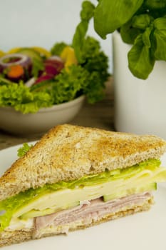 fresh tasty club sandwich with cheese and ham on wooden table