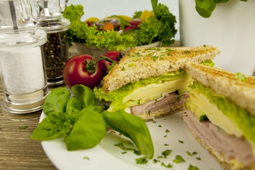 fresh tasty club sandwich with cheese and ham on wooden table