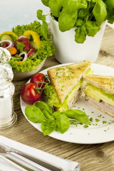 fresh tasty club sandwich with cheese and ham on wooden table
