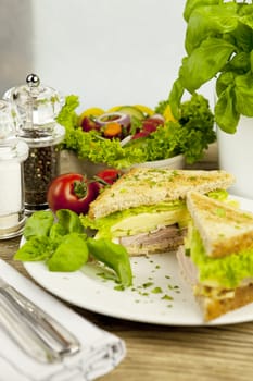 fresh tasty club sandwich with cheese and ham on wooden table