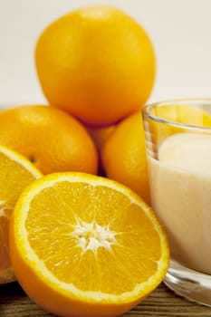 fresh tropical orange yoghurt shake dessert on wooden background