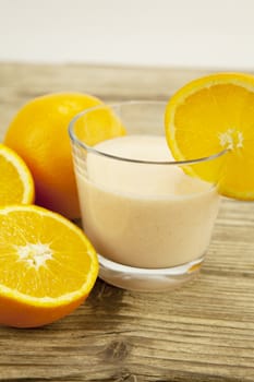 fresh tropical orange yoghurt shake dessert on wooden background
