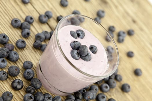 fresh delicious blueberry yoghurt shake dessert on wooden background