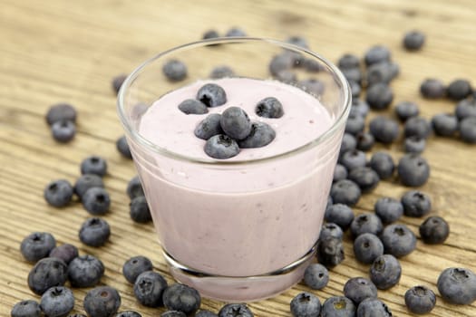fresh delicious blueberry yoghurt shake dessert on wooden background