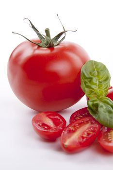 fresh red tomatoes with balsamic and oilve oil isolated on white background