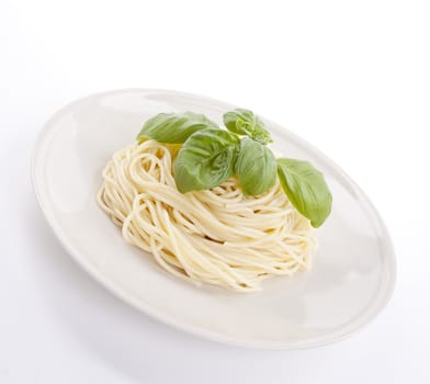 fresh delicious pasta with basil isolated on white background