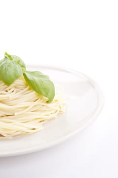 fresh delicious pasta with basil isolated on white background