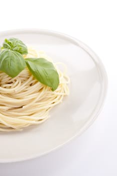 fresh delicious pasta with basil isolated on white background