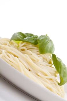 fresh delicious pasta with basil isolated on white background