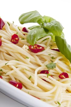 fresh pasta with chilli and basil with salad isolated on white background