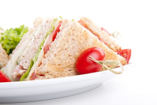 fresh tasty club sandwich with lettuce cheese ham and toast isolated on white background