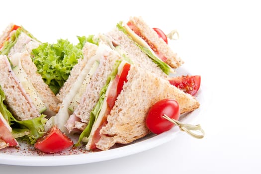 fresh tasty club sandwich with lettuce cheese ham and toast isolated on white background