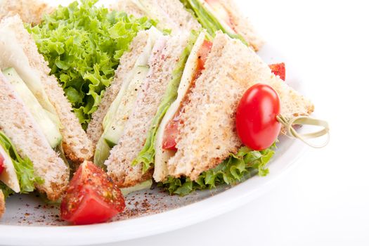 fresh tasty club sandwich with lettuce cheese ham and toast isolated on white background