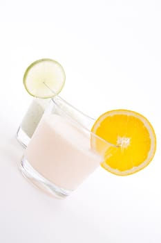 fresh tasty lime and orange yoghurt shake cream isolated on white background