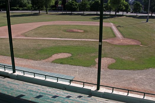 An unoccupied baseball field, shot from the bleachers.
