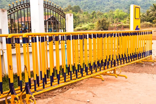 Yellow iron fence located in the gas station.