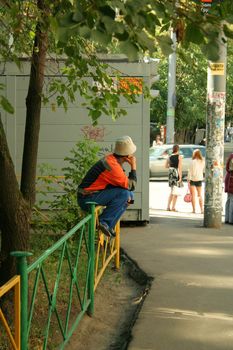 Industrial Construction Worker sitting on the fence