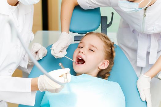 Little girl sitting in the dentists office