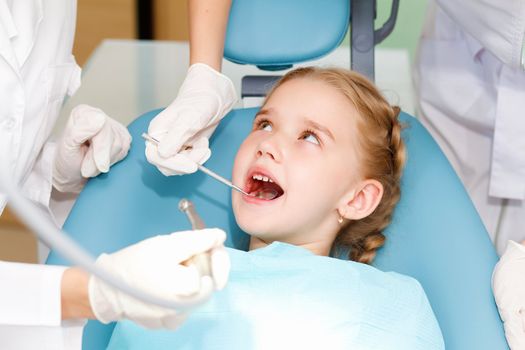 Little girl sitting in the dentists office