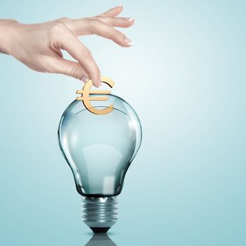 Hand and money inside an electric light bulb