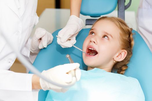 Little girl sitting in the dentists office