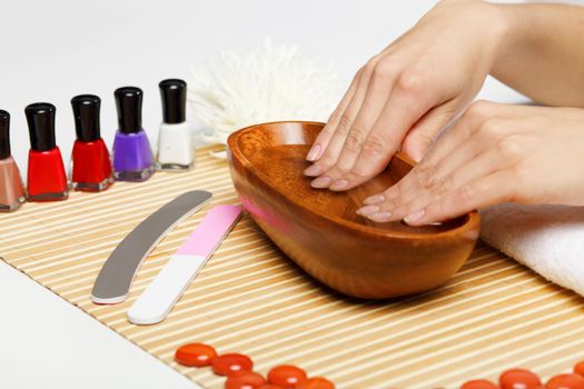 Young woman is getting manicure in a beauty salon