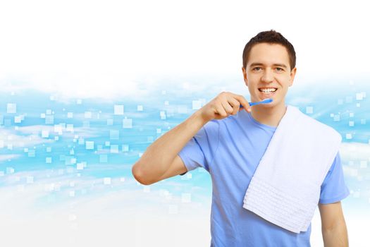 Young man in blue shirt brushing his teeth