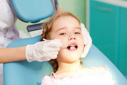 Little girl sitting in the dentists office