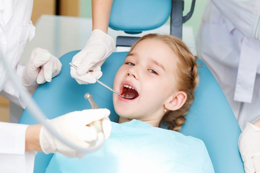 Little girl sitting in the dentists office