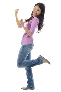 Portrait of excited Asian woman celebrating success over white background