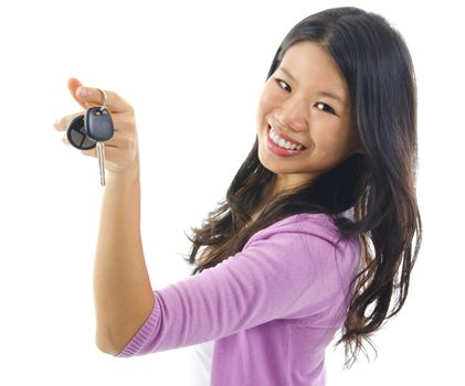 Happy Young pan asian woman showing her new car key, isolated on white, focus on car key