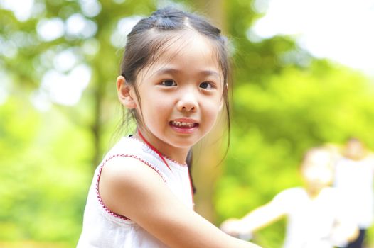 Little Asian girl riding bike outdoor