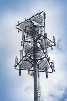 telecommunications tower against a cloudy sky