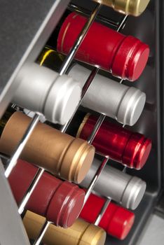 red and white wine bottles stacked in a wine cooler