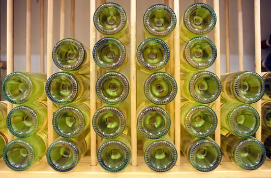 White wine bottles stacked on top of each other with narrow depth of field