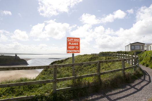 a warning sign of danger at a cliff edge walk in Ballybunion county Kerry Ireland