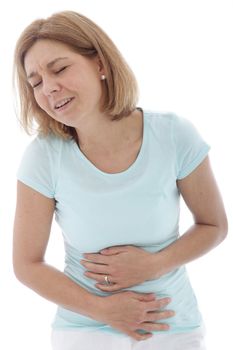 Woman with stomach pain clutching her tummy with both hands while grimacing in anguish, isolated on white